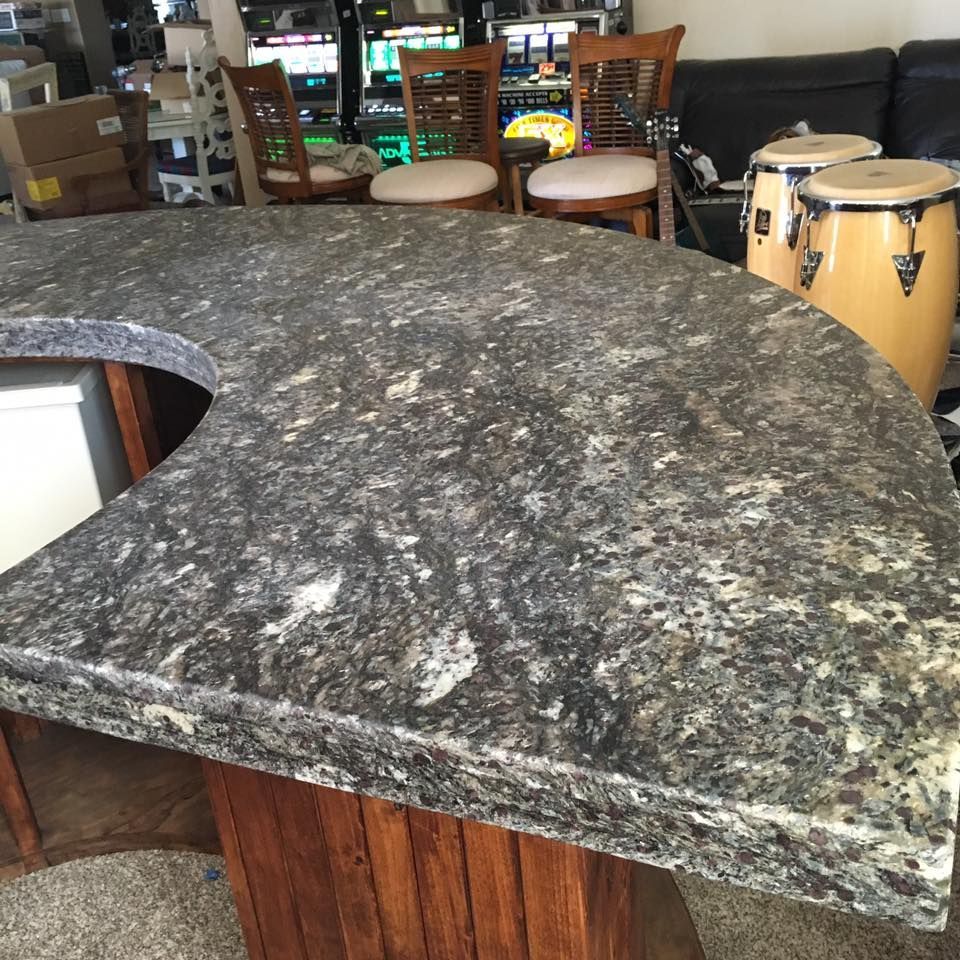 A kitchen counter with a drum set in the background