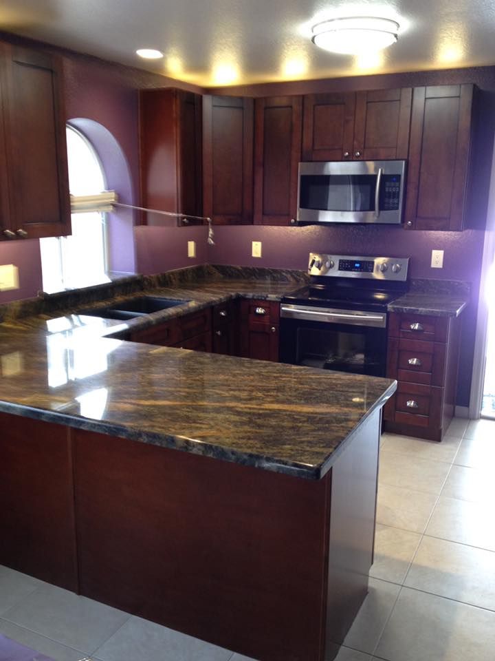 A kitchen with stainless steel appliances and granite counter tops