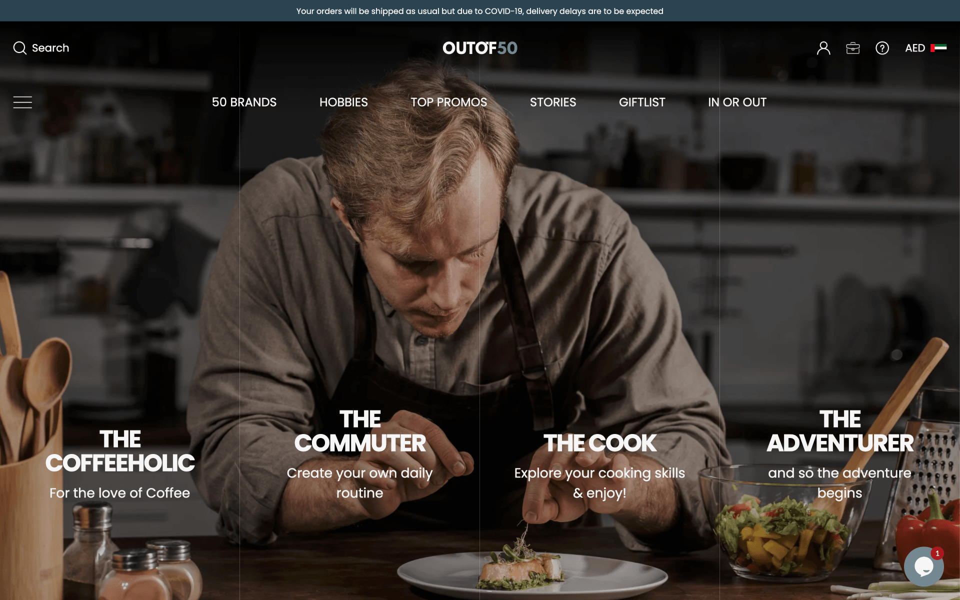 A man is sitting at a table eating a plate of food.