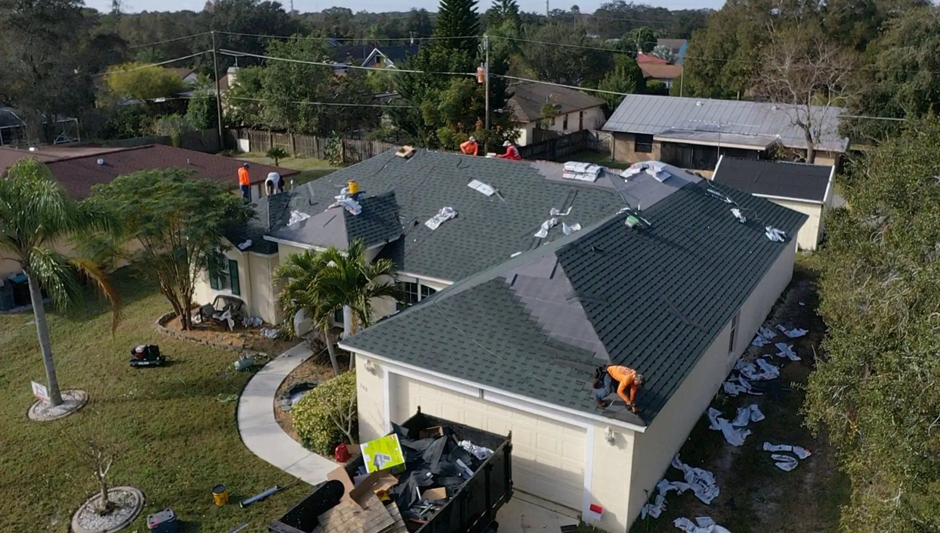 JT roofing team working on a residential roof in Melbourne, FL