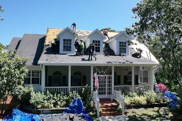 JT roofing team working on a residential roof in Melbourne, FL
