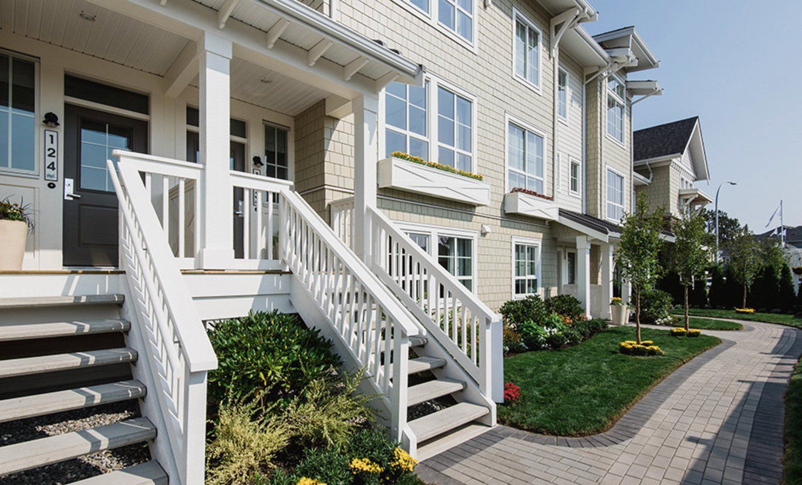 A white house with stairs leading up to the front door
