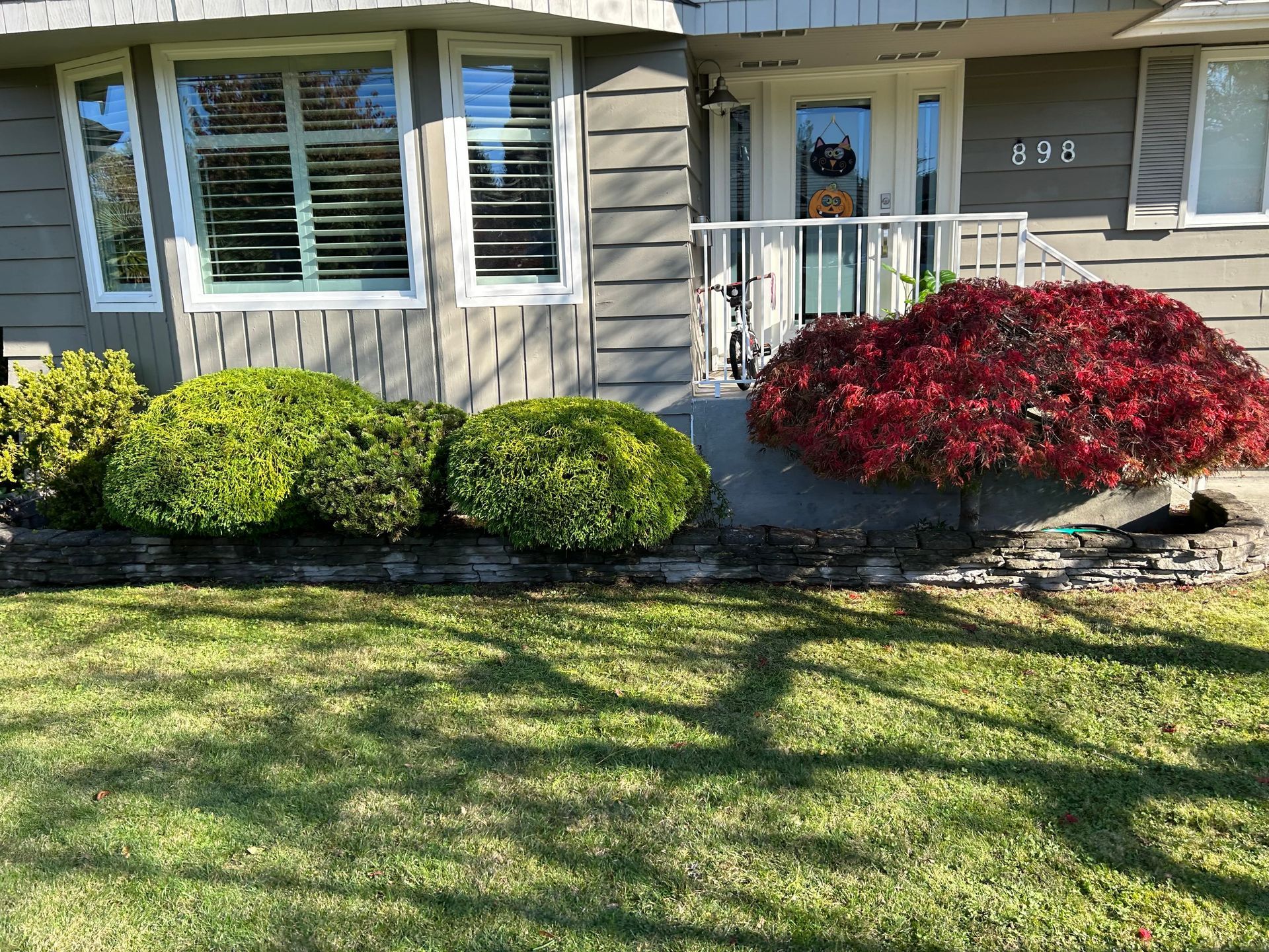 shrub trimming service around front porch.