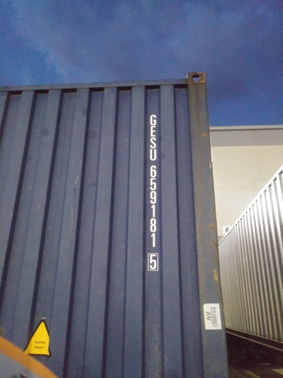 Blue shipping container with white text 