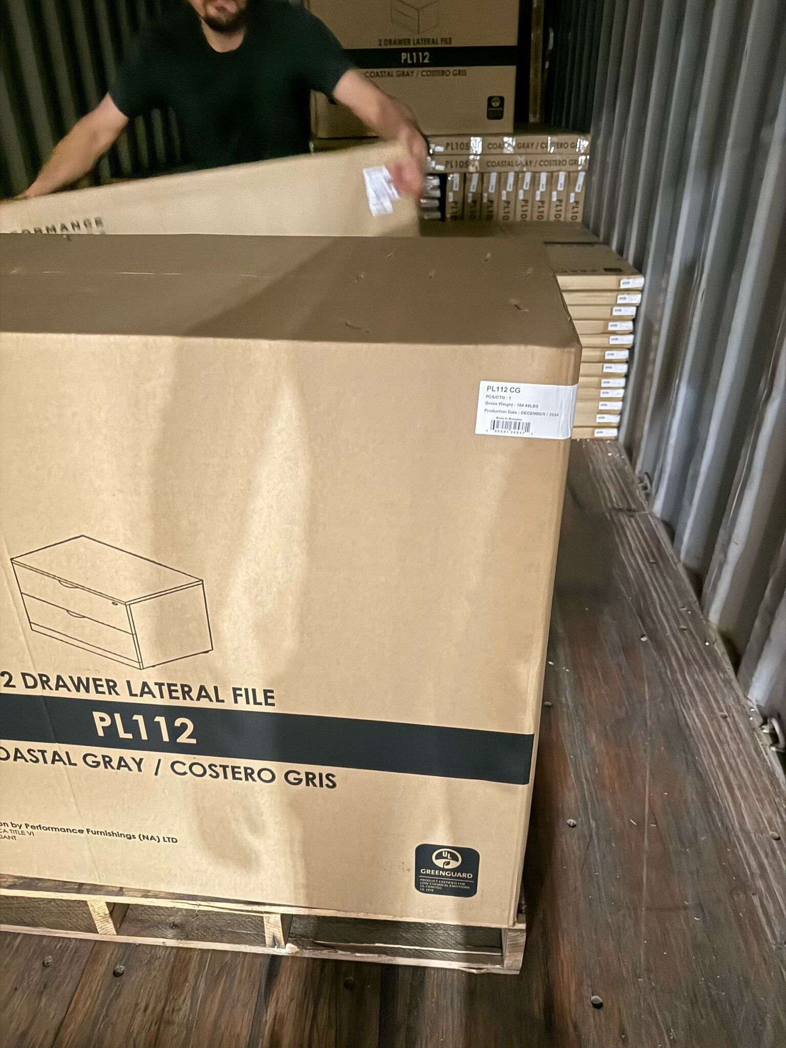 Person loading large boxes labeled 