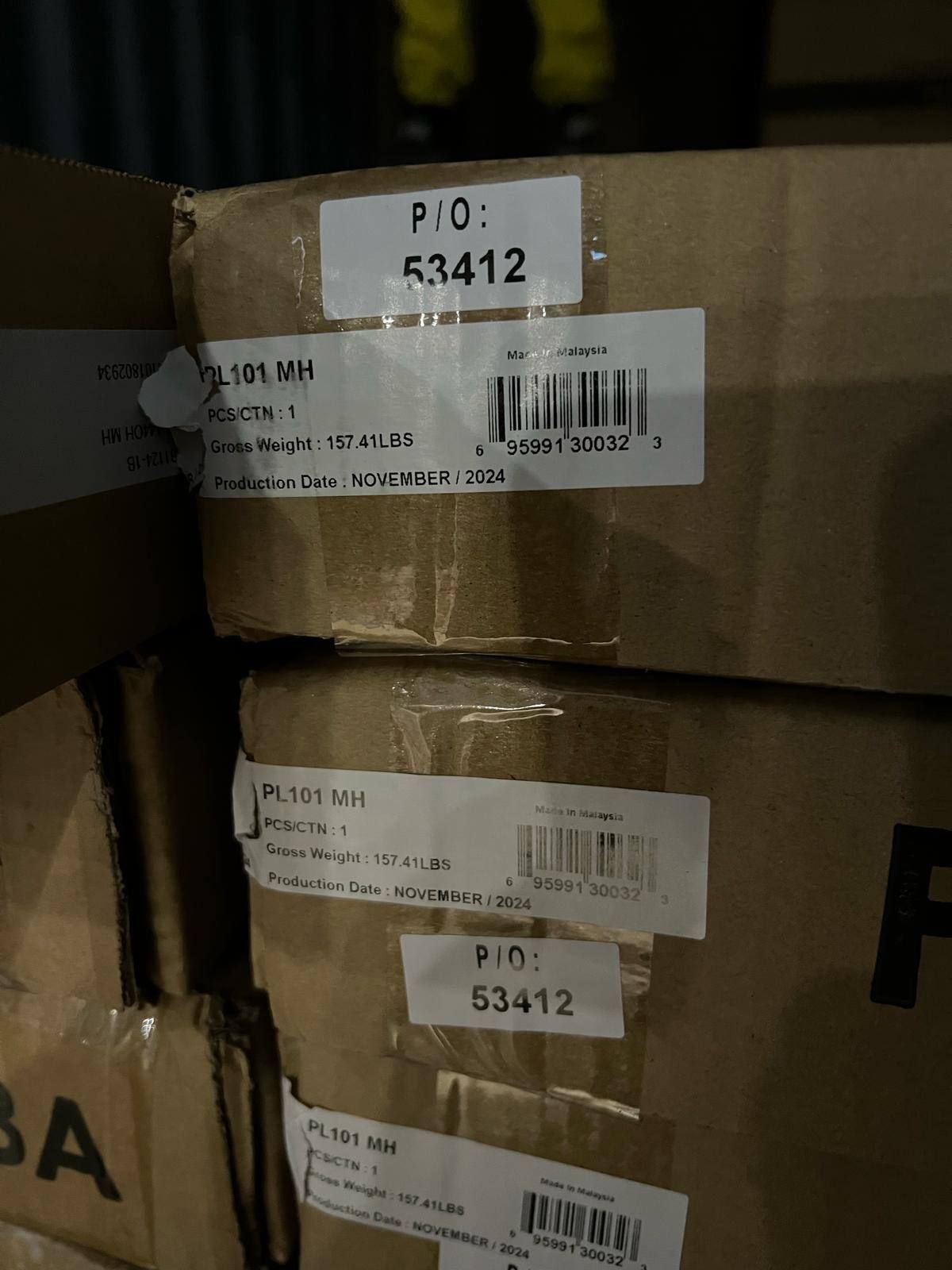 Boxes stacked with labels showing product IDs and barcodes.