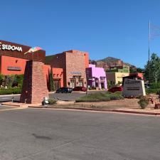 A group of buildings sitting next to each other on the side of a road.