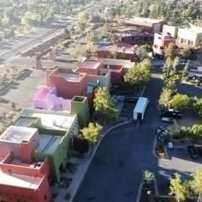An aerial view of a residential area with lots of buildings and trees.