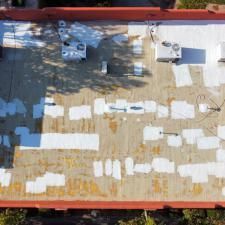 An aerial view of a roof with a lot of white squares on it.