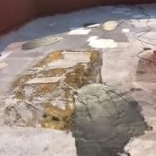 A close up of a concrete floor with a lot of holes in it.