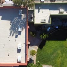 An aerial view of a building with a roof that is covered in shingles.