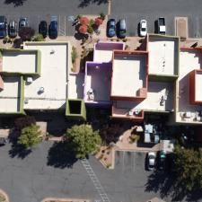An aerial view of a building with cars parked in front of it.