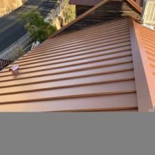A close up of a brown metal roof on a house.