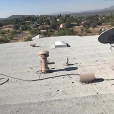 There is a satellite dish on the roof of a building.
