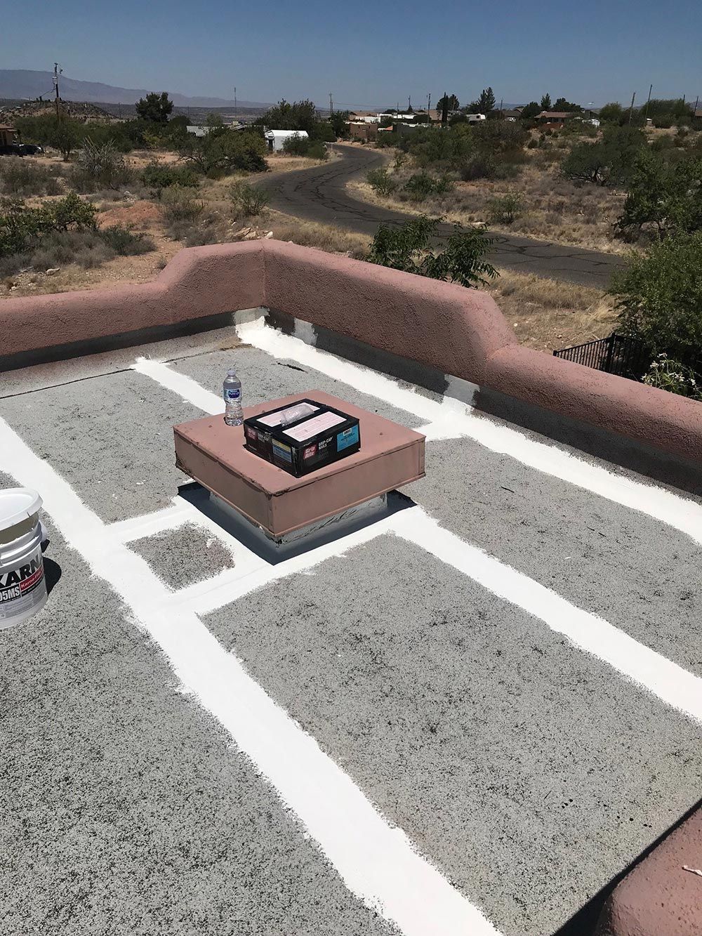 A roof with white lines and a box on top of it.