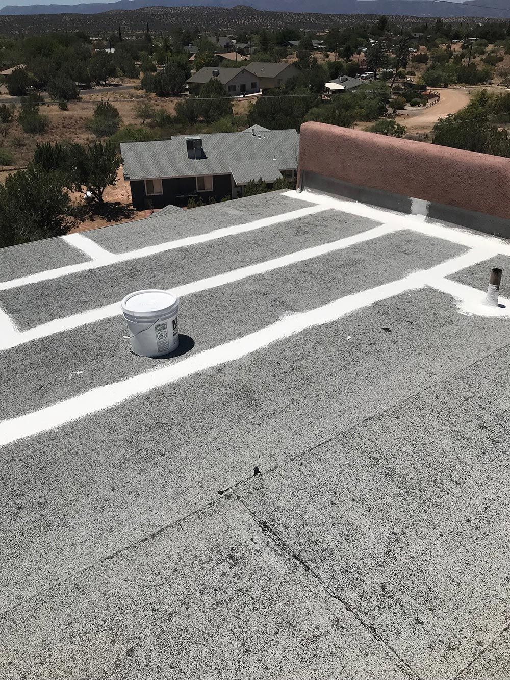 A bucket is sitting on the roof of a building.