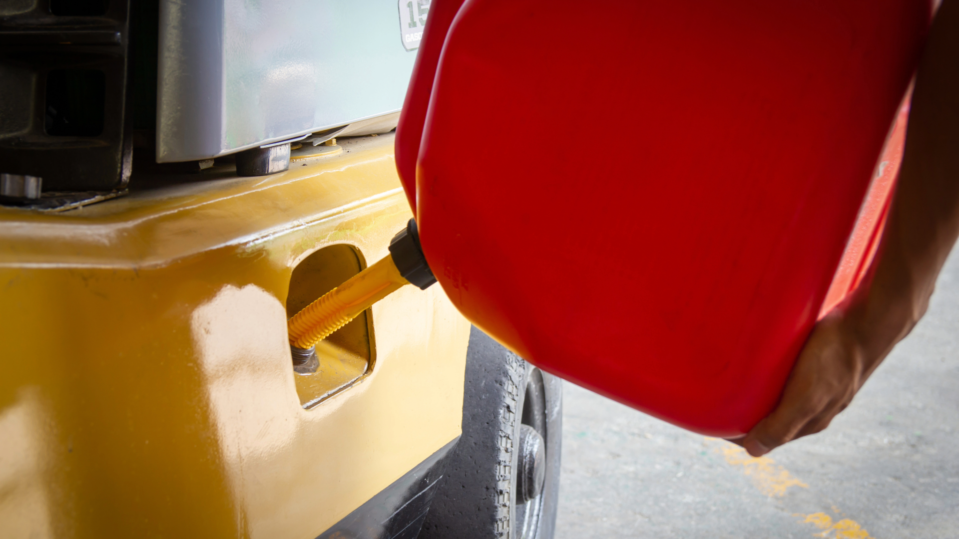 Photo of a diesel forklift being filled up with a gas can. Showing the difference between diesel forklifts vs electric and lp. 