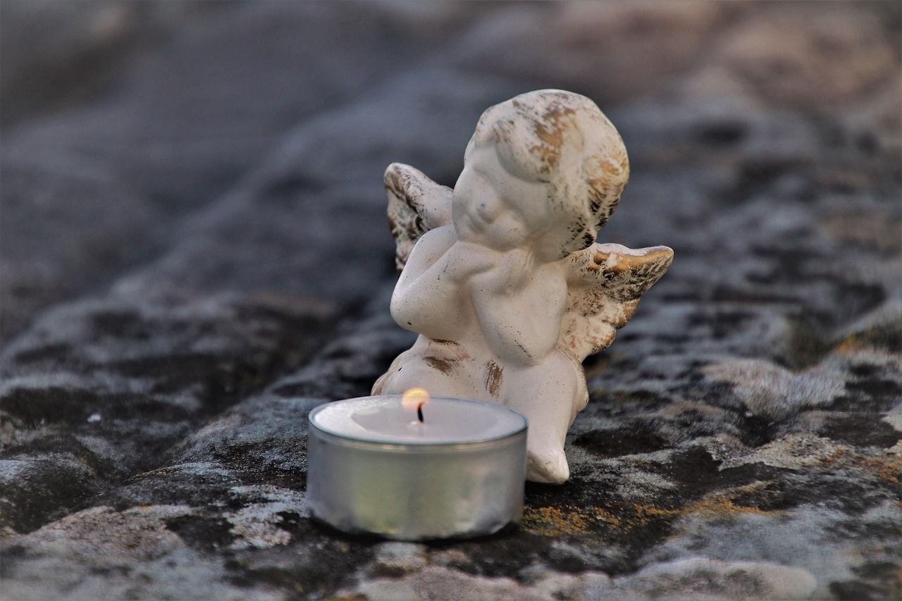 Angel statue in a cemetery symbolizing sadness and memory