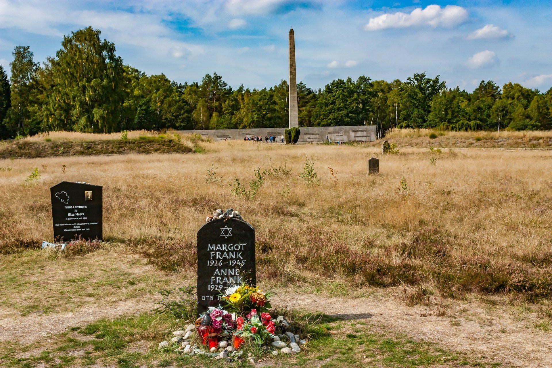 Black tomb adorned with flowers under a bright sky symbolizing love and remembrance in Edinburg, TX.