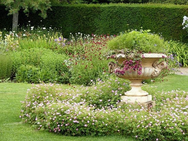 Stoneware urn with blooming flowers in a peaceful garden memorial setting