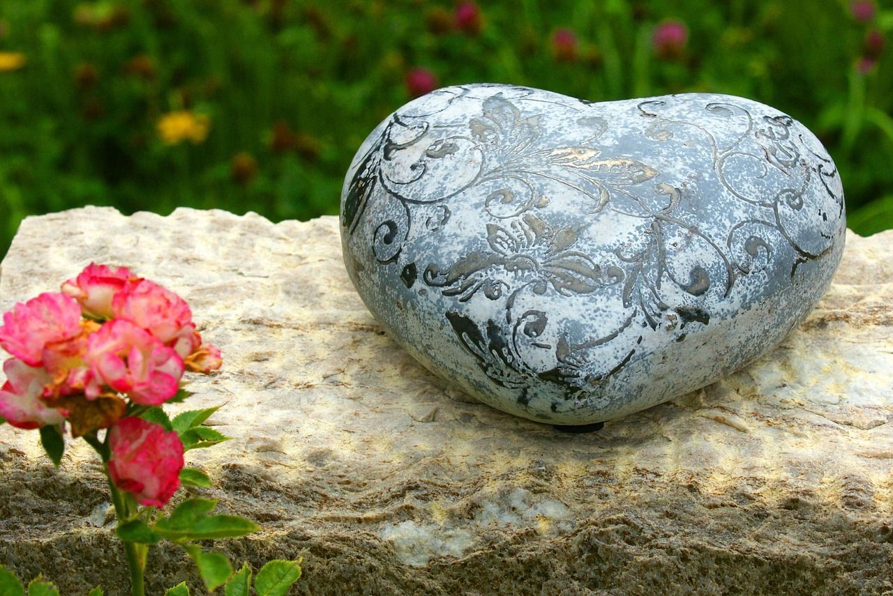 Heart-shaped floral tribute placed at a grave symbolizing grief, love, and heartfelt remembrance.
