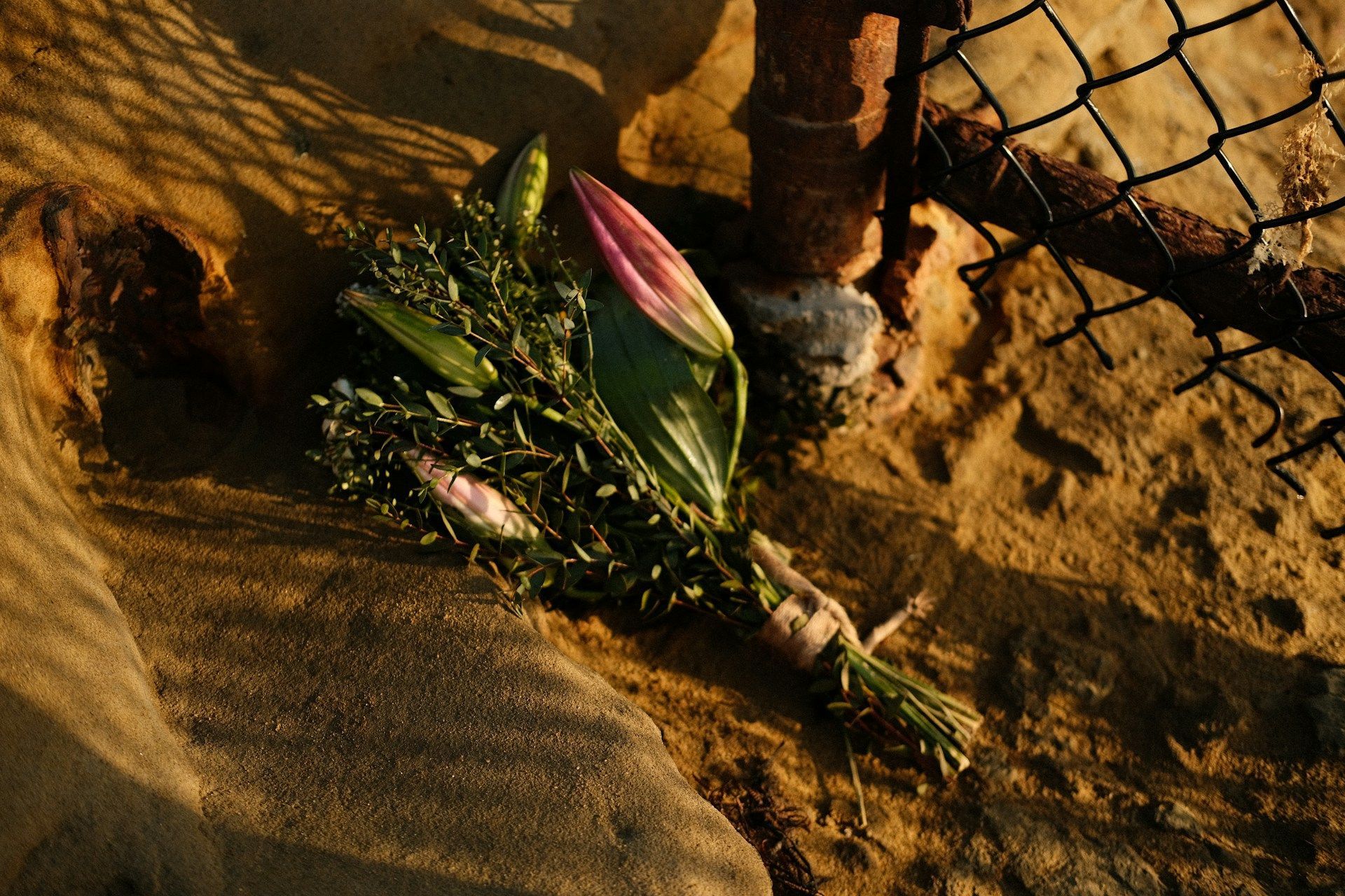 Bouquet of flowers placed by fence in loving memory of a departed soul in Edinburg, TX.
