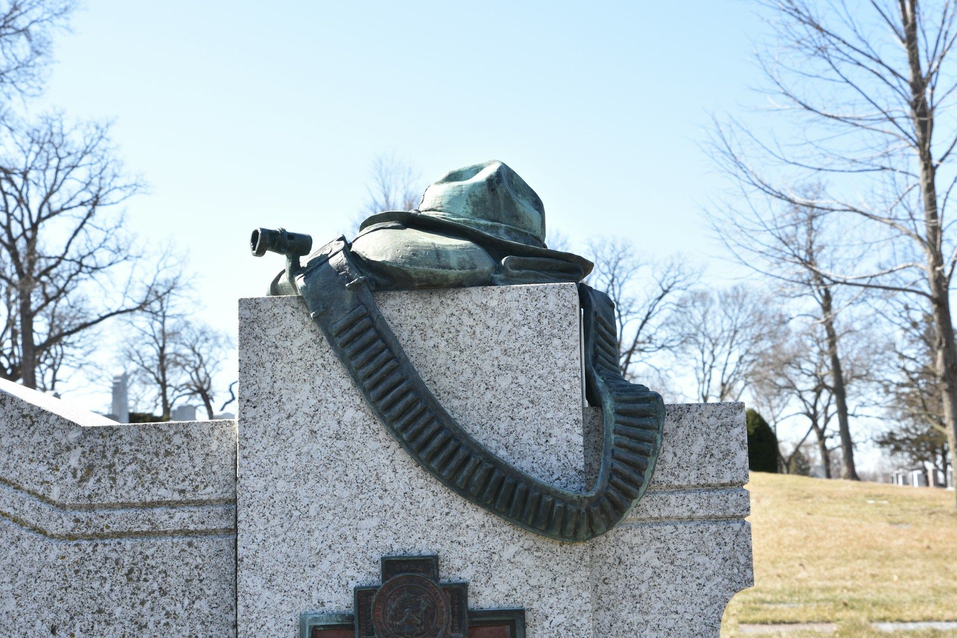 Stone statue of a man with a hat, standing as a memorial tribute honoring history and remembrance