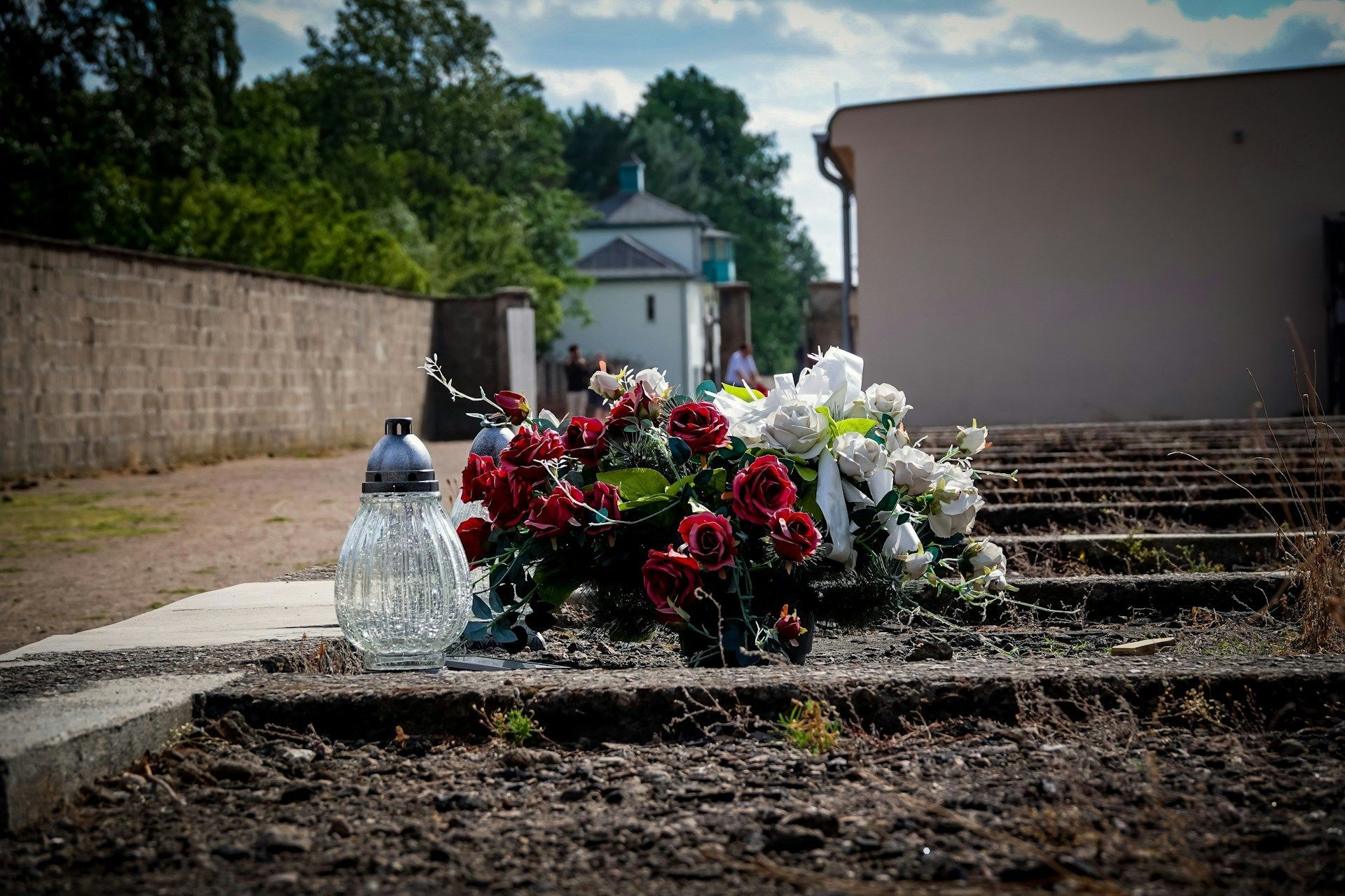 White and red roses placed on memorial steps representing eternal love and honor at Memorial Funeral Home.