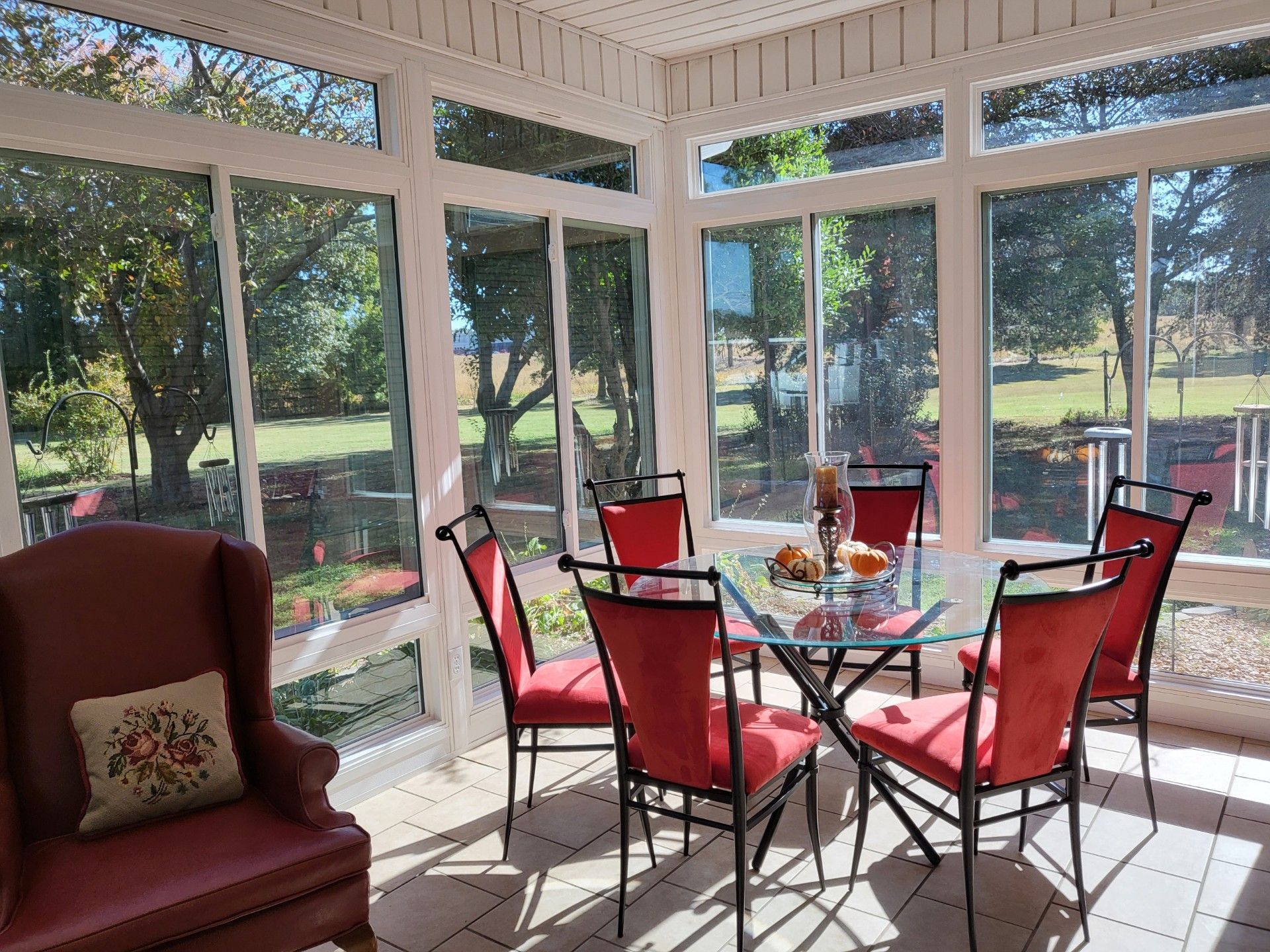 A sunroom with a table and chairs in it