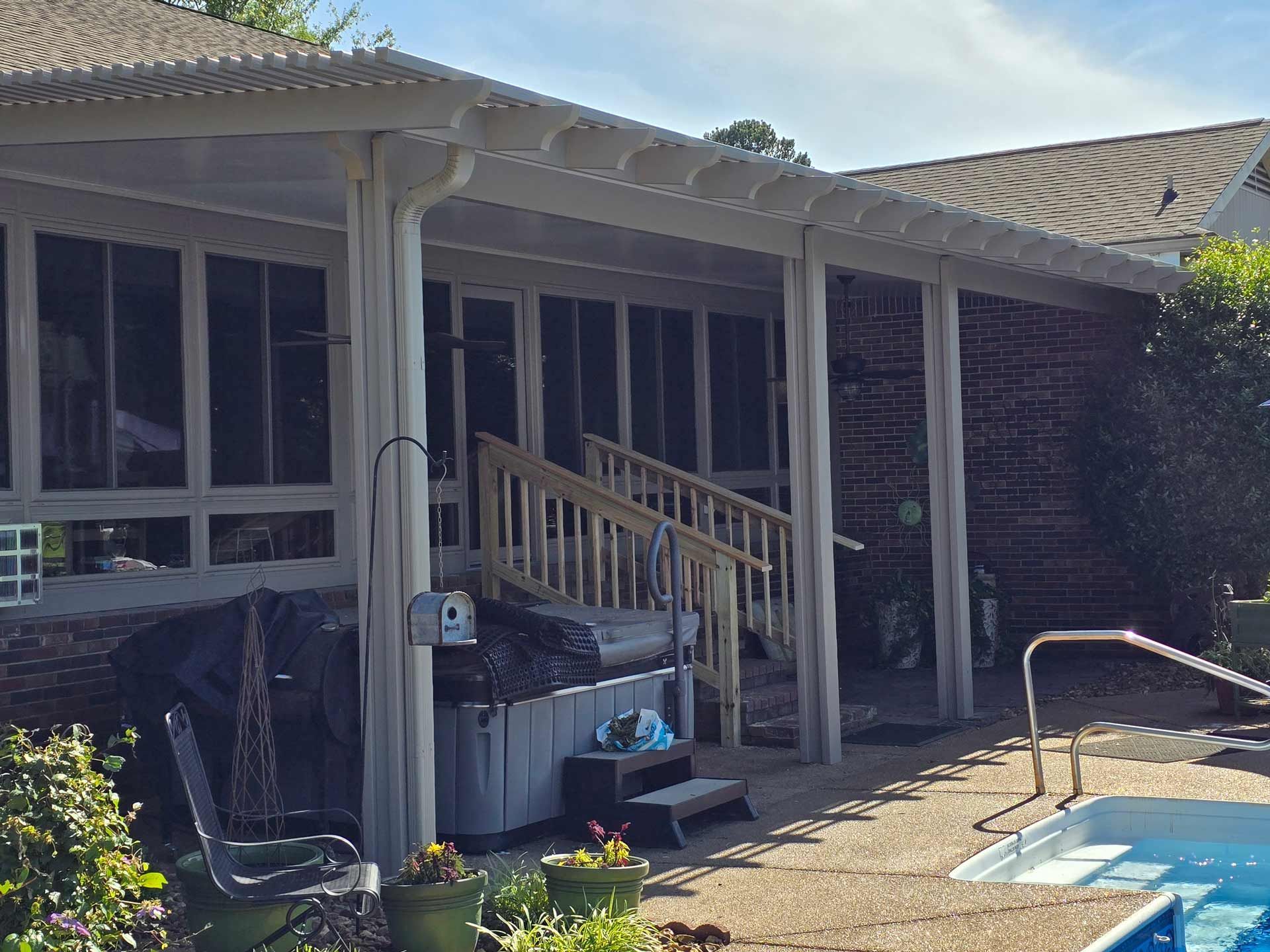 There is a swimming pool in the backyard of a house