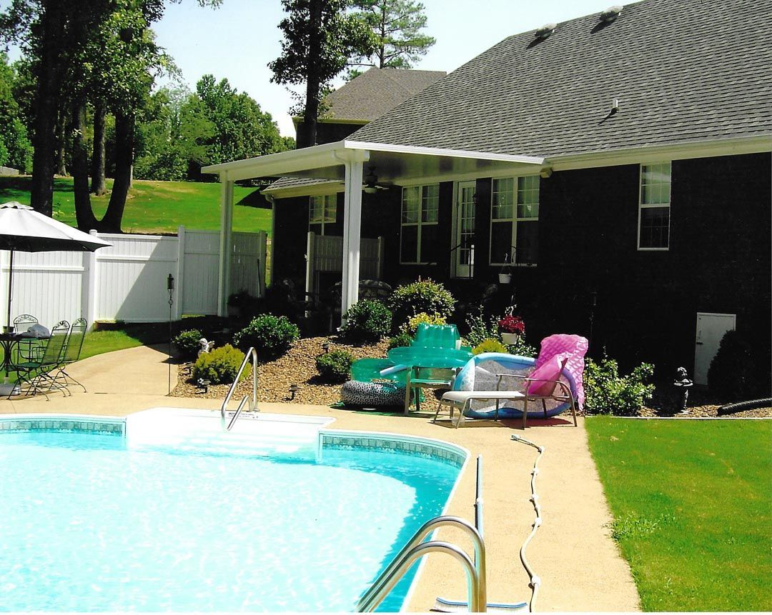 A house with a swimming pool in front of it