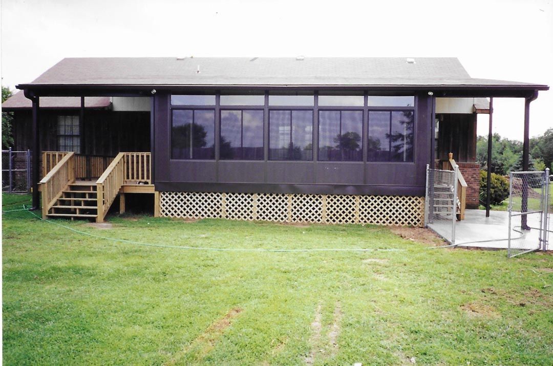 A house with a screened in porch and stairs