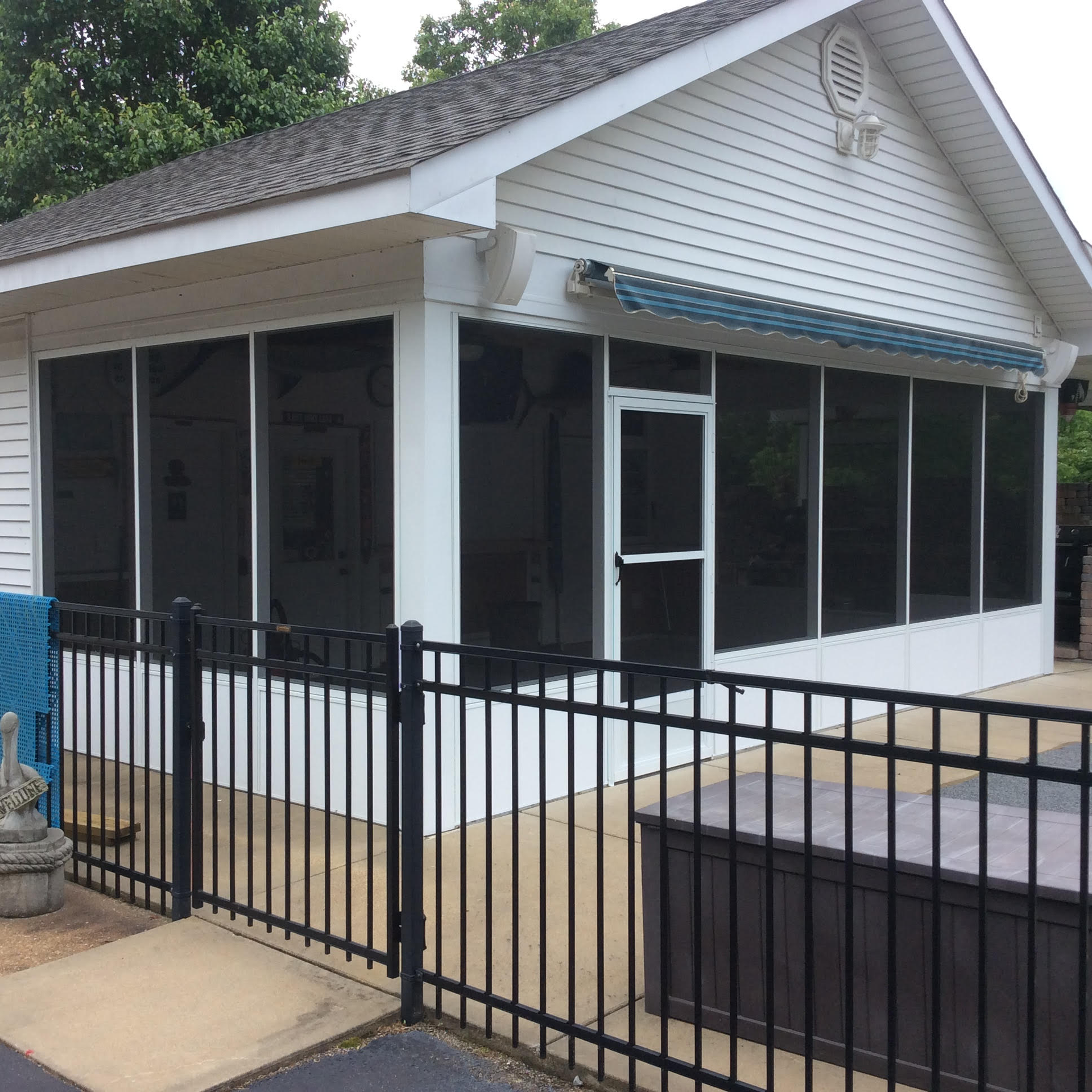 A screened in porch with a black fence around it