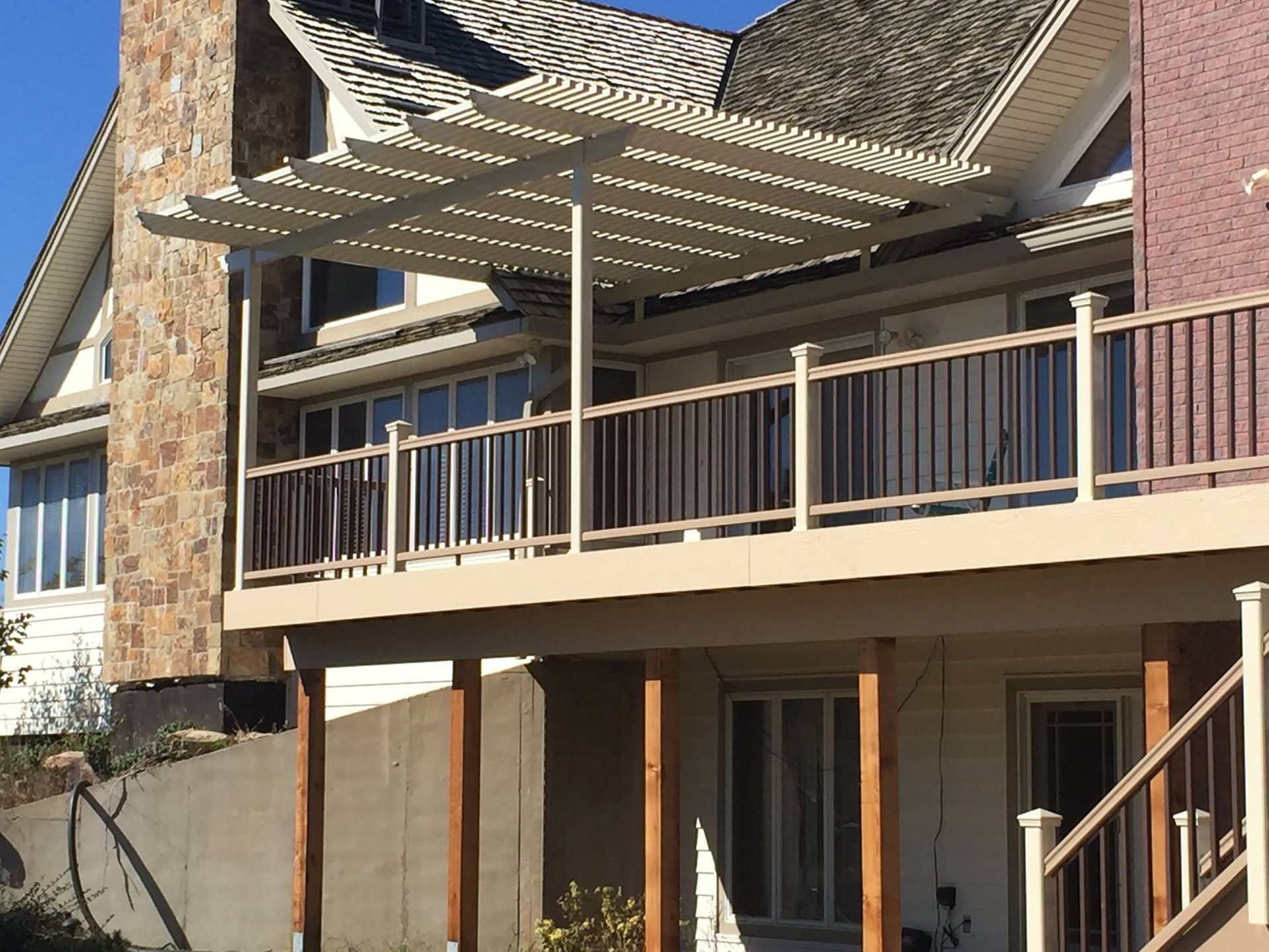 A large house with a large deck and stairs
