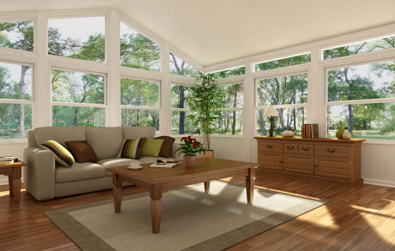 A living room with a couch , coffee table , and lots of windows