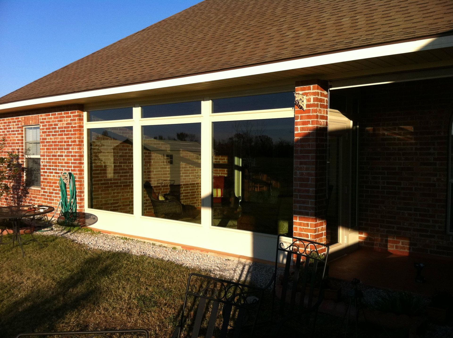 A house with a lot of windows and a brick wall