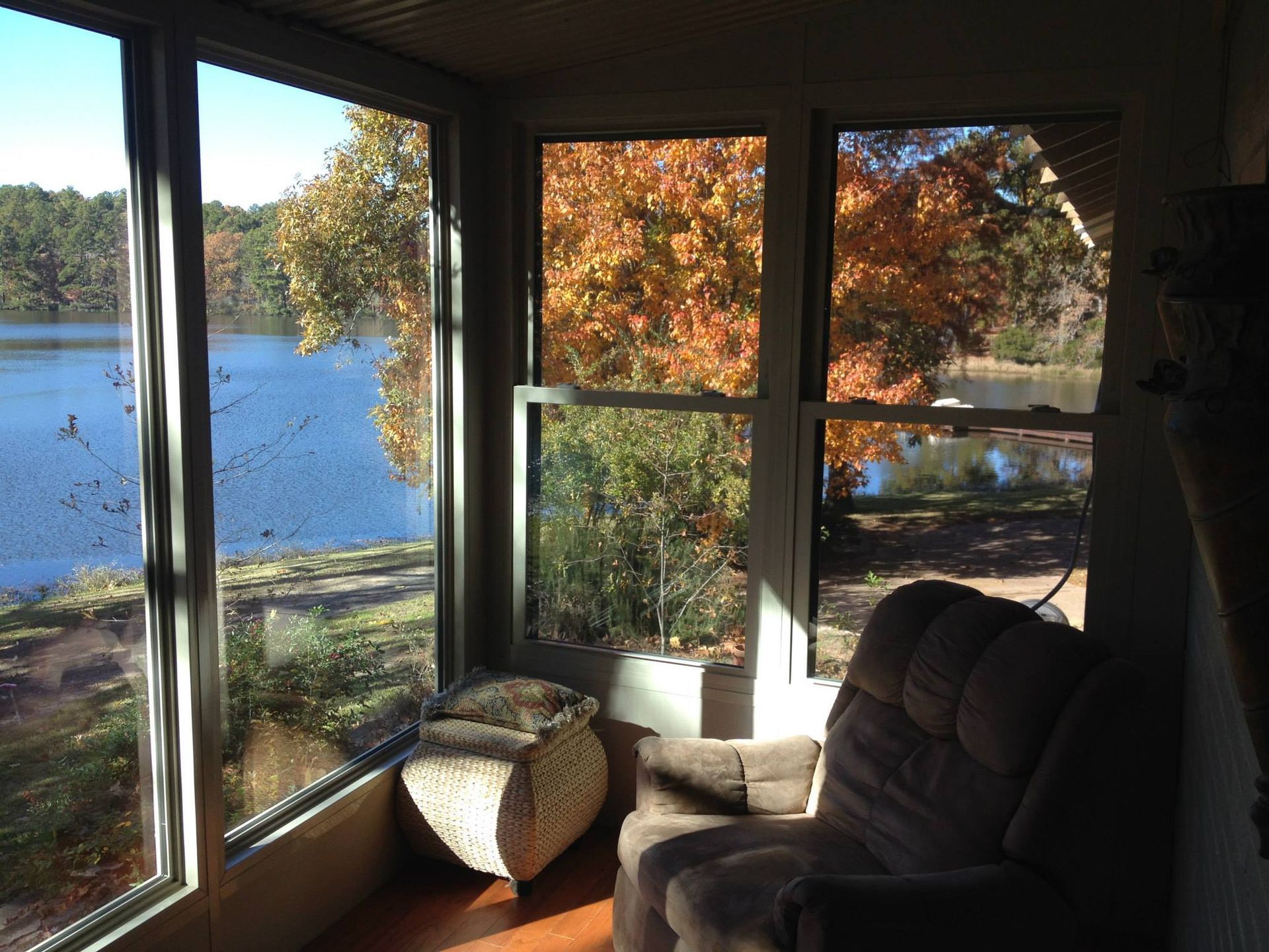 A living room with a view of a lake and trees
