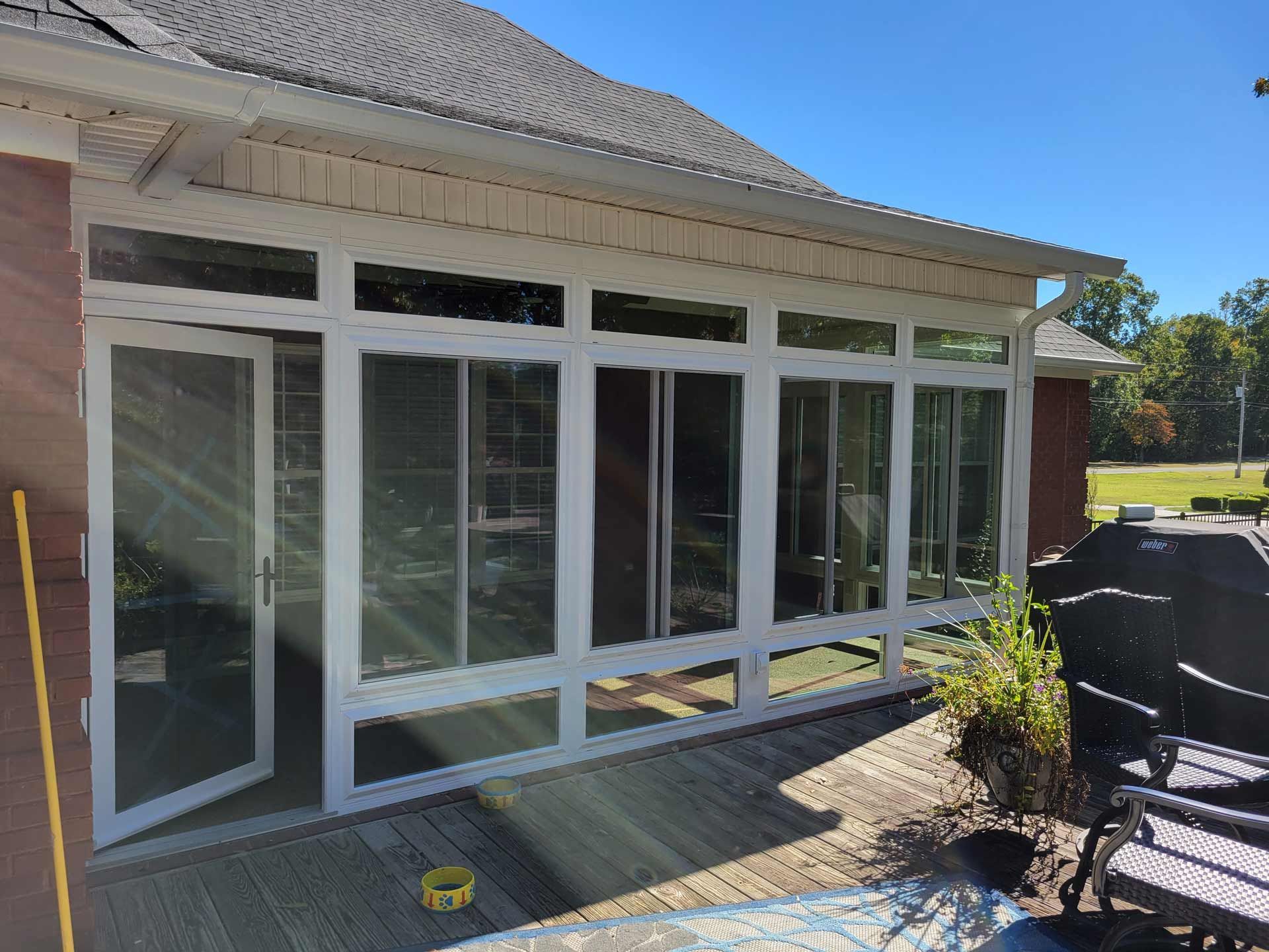 A sun room with a lot of windows and sliding glass doors