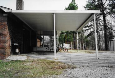A carport with bikes parked underneath it