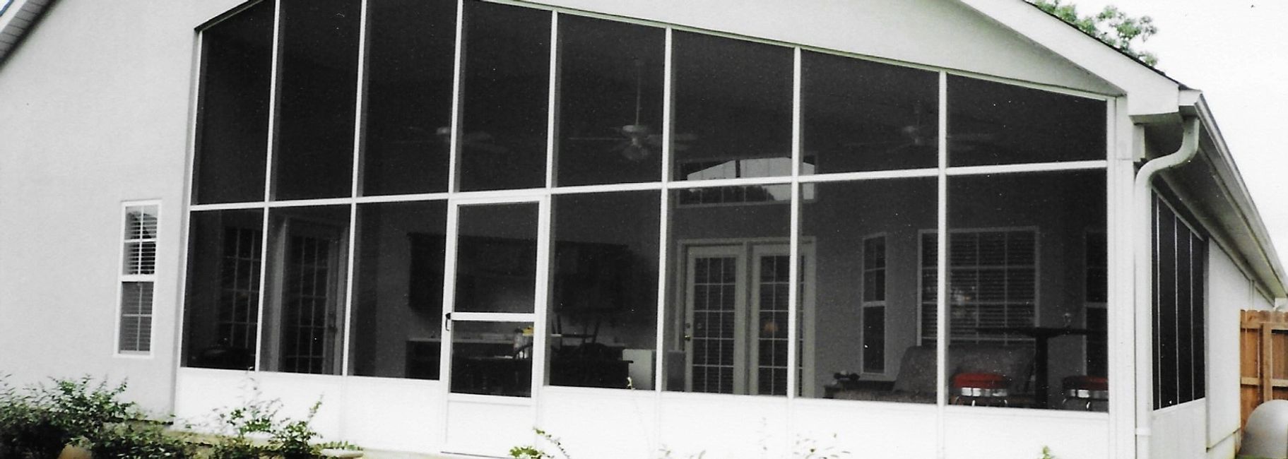 A screened in porch with a lot of windows