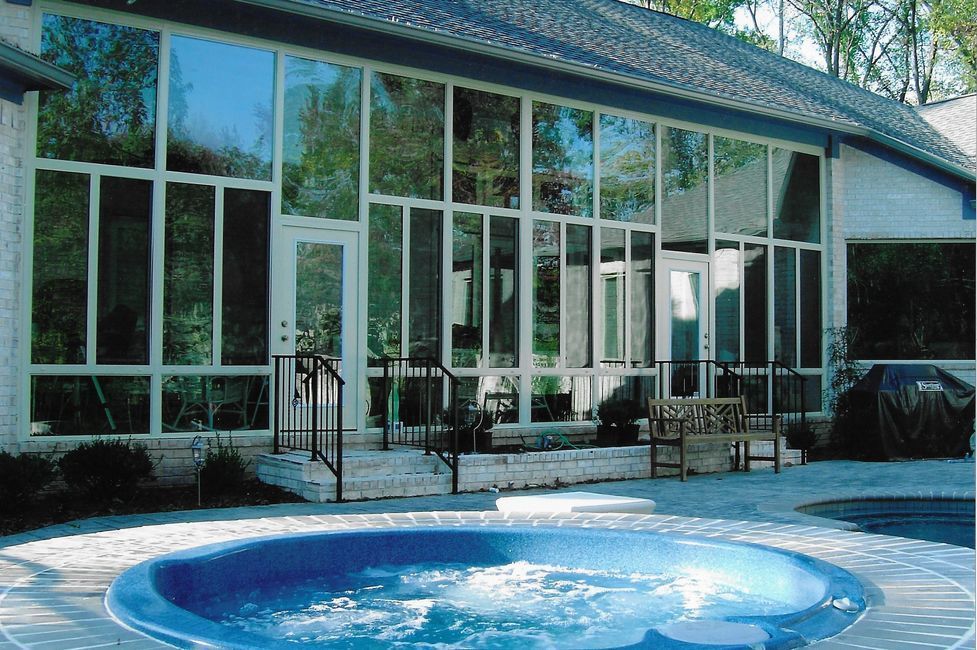 A large house with a hot tub in front of it