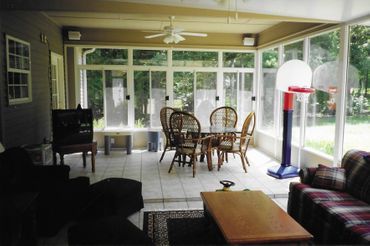 A living room with a table and chairs and a basketball hoop