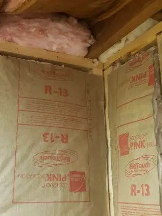 R-13 rated faced Batt insulation tucked into corners and in rafters