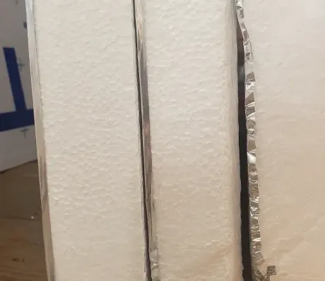 Rigid foam board with reflective layer ready to be installed by Akron Home Insulators