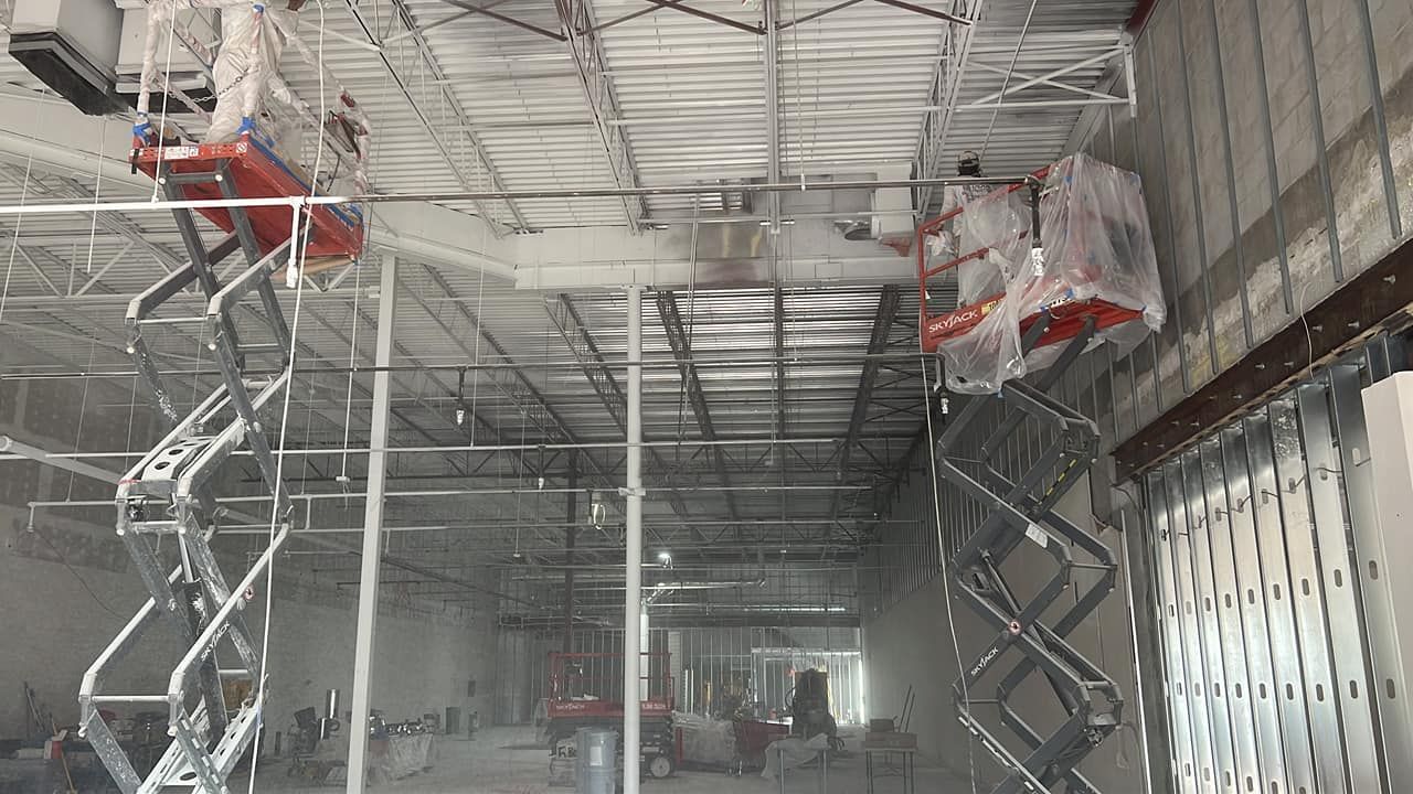 A large building with a ceiling that is being painted.