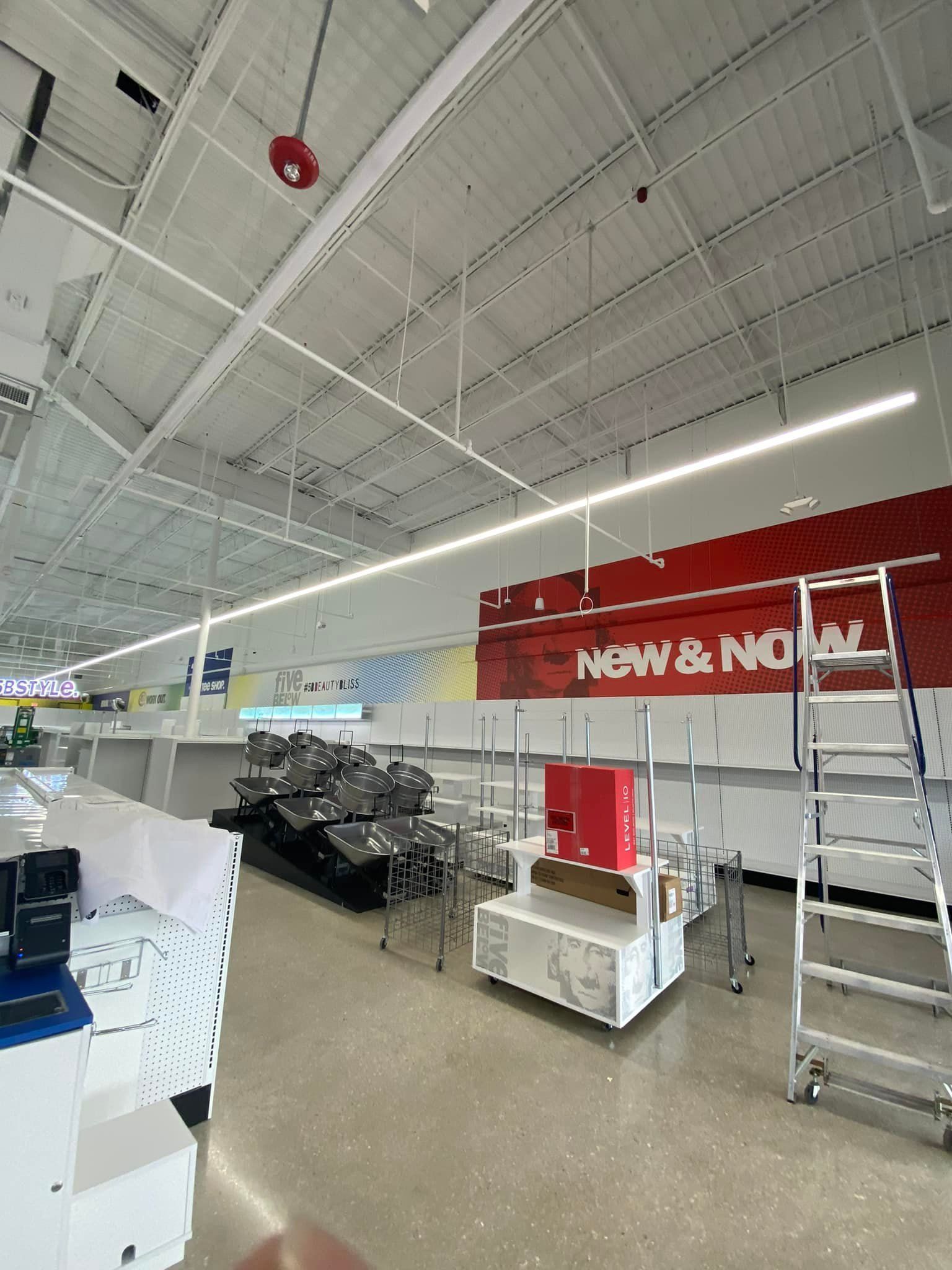 The inside of a store with a red sign that says new & no