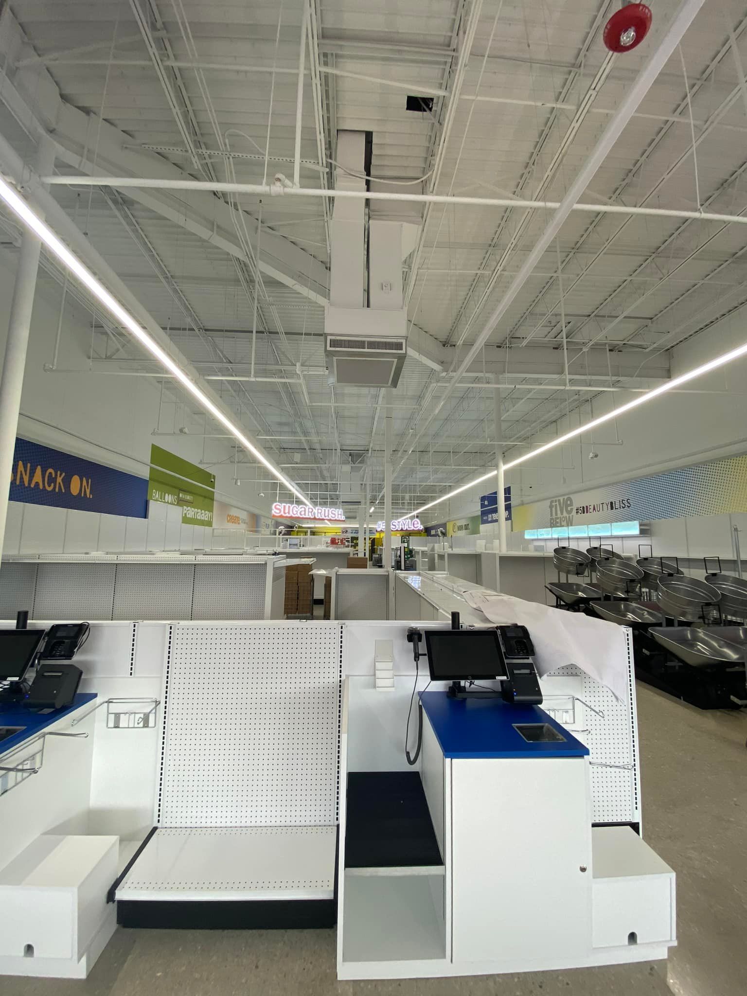 The inside of a store with a ceiling fan hanging from it.