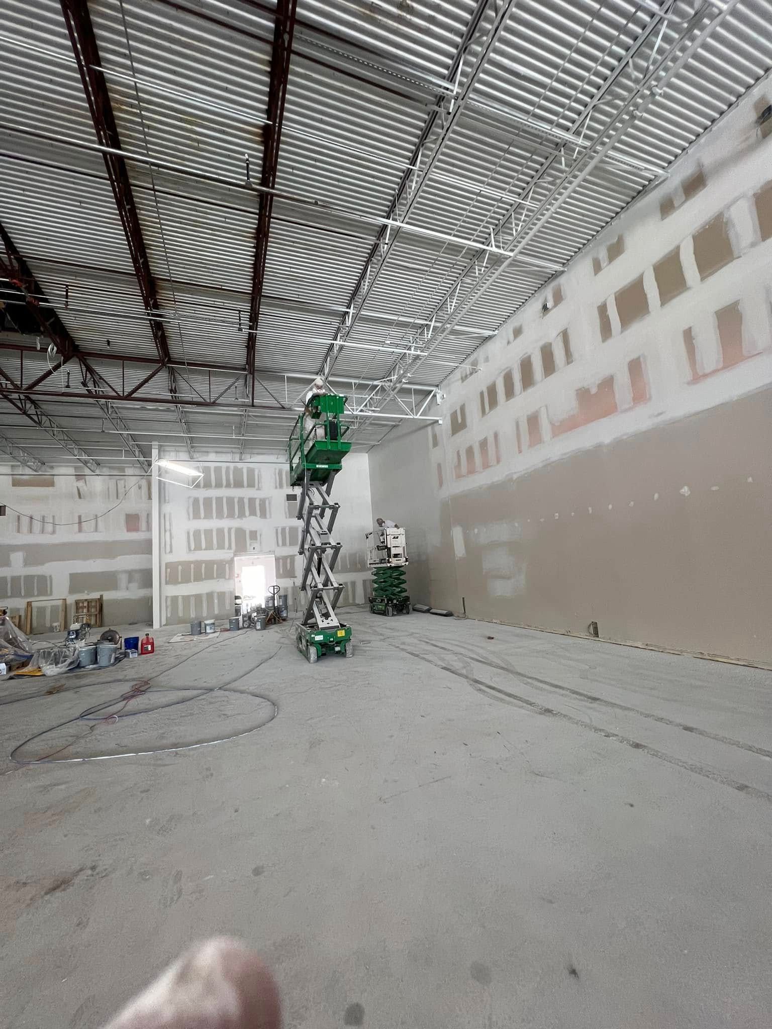 A person is standing in the middle of a large building.