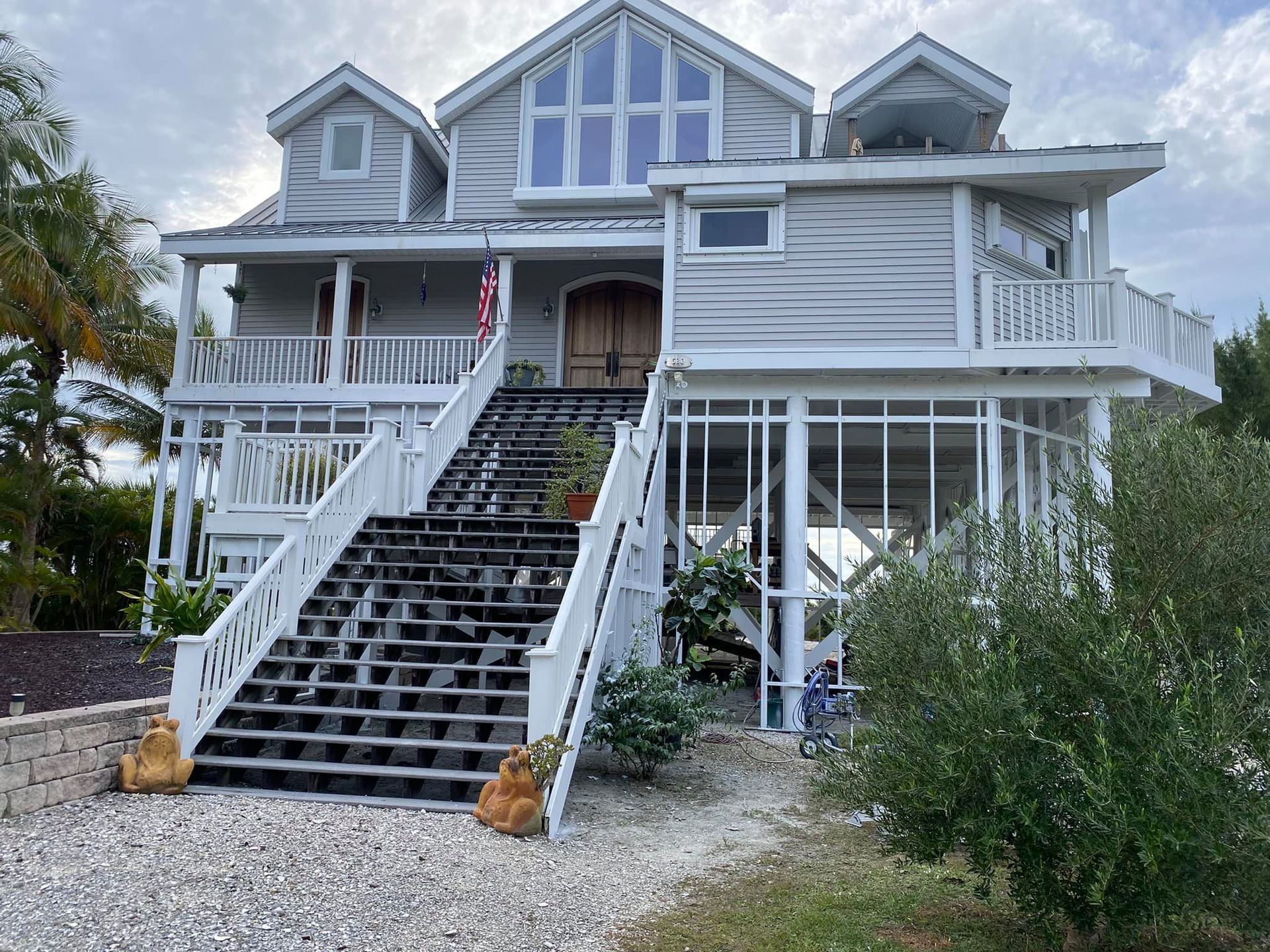 A large white house with stairs leading up to it