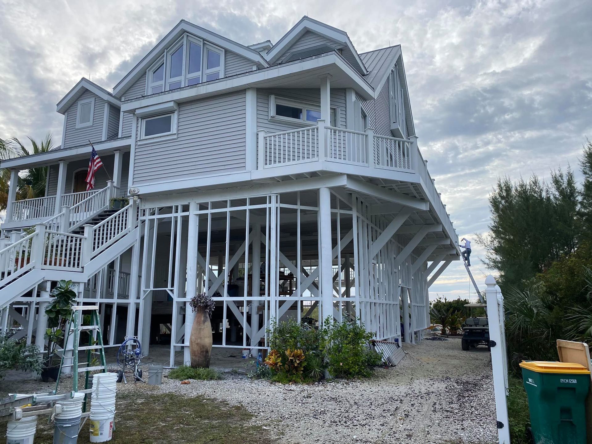 A large white house with a lot of windows is being built.